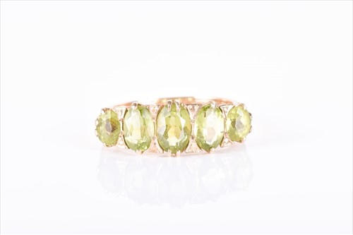 Lot 612 - A 9ct yellow gold and peridot ring set with...
