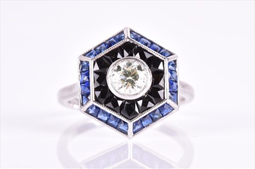 Lot 524 - An unusual diamond, sapphire, and onyx ring in...