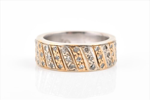 Lot 589 - A yellow and white metal and diamond eternity...
