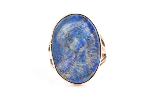 Lot 613 - A yellow metal and lapis lazuli cameo ring the...