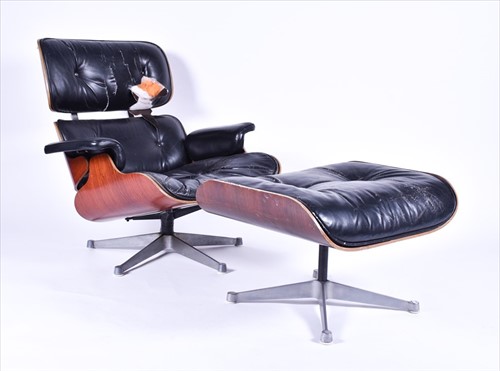 Lot 33 - An Eames-style lounge chair and matching...