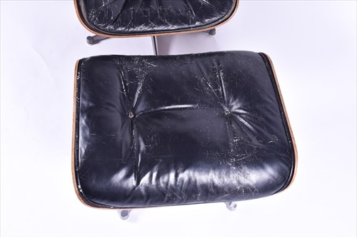 Lot 33 - An Eames-style lounge chair and matching...
