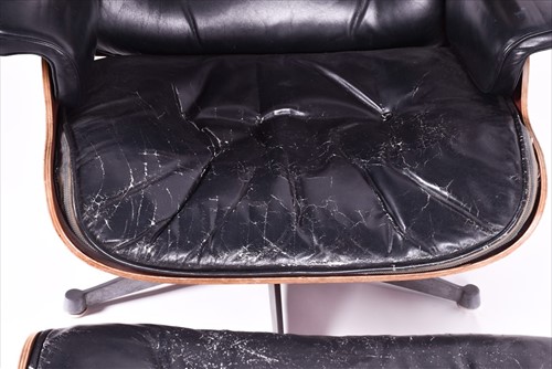Lot 33 - An Eames-style lounge chair and matching...