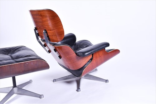 Lot 33 - An Eames-style lounge chair and matching...