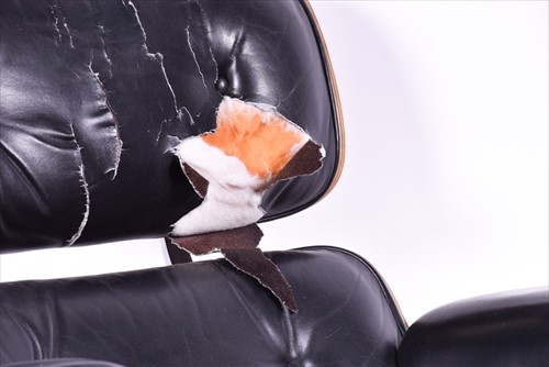 Lot 33 - An Eames-style lounge chair and matching...