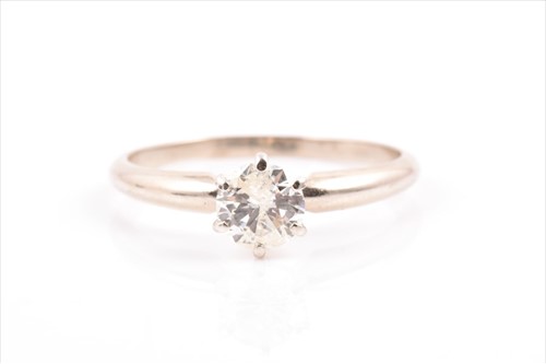 Lot 623 - A 14k gold and solitaire diamond ring set with...