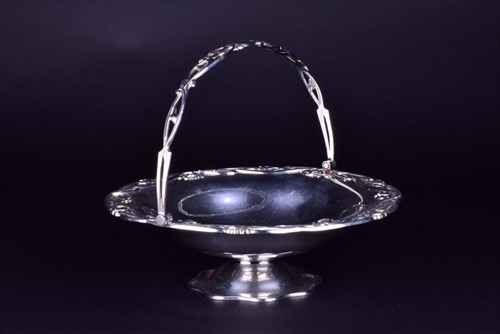 Lot 398 - An Edwardian silver silver swing handle...