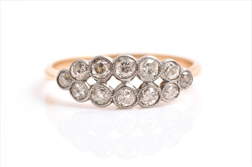 Lot 629 - A yellow metal and diamond ring set with two...