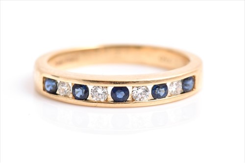Lot 620 - A diamond and sapphire ring the yellow metal...