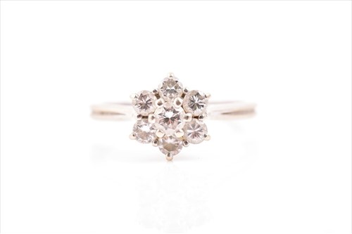 Lot 658 - A diamond floral cluster ring set with seven...