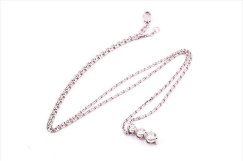 Lot 523 - A 9ct white gold and diamond pendant necklace...