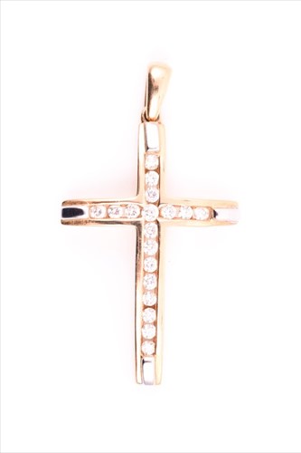 Lot 512 - A yellow metal and diamond cross pendant...