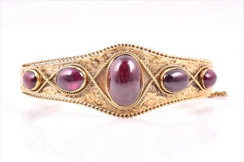 Lot 515 - A Victorian yellow metal and garnetÂ bangle...