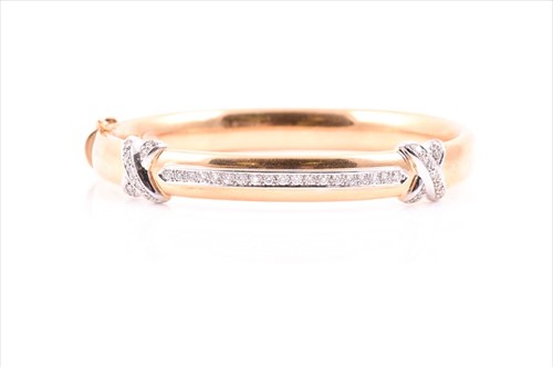 Lot 511 - A yellow metal and diamondÂ bangle of rounded...