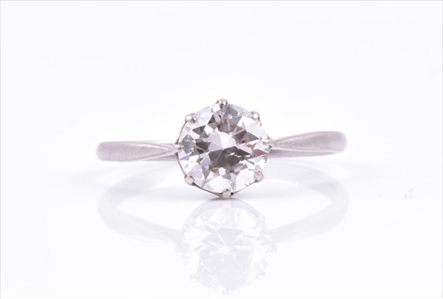 Lot 467 - A solitaire diamond ring set with a round...