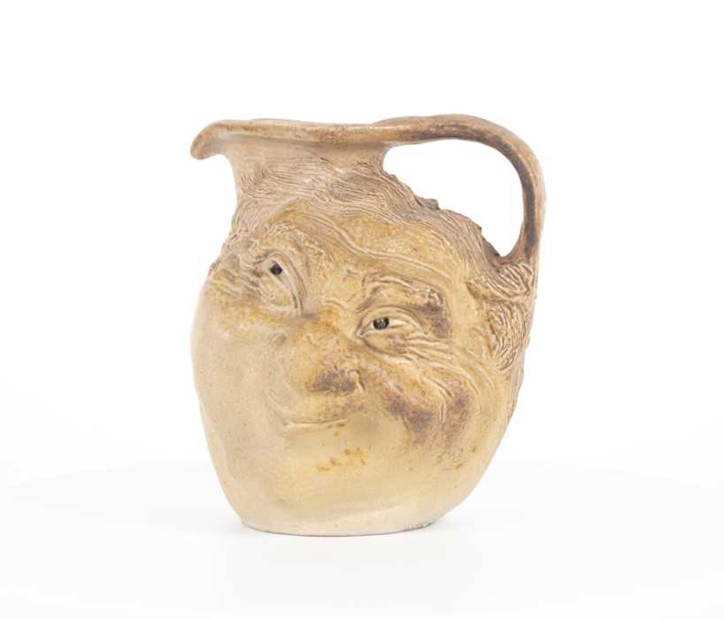 Lot 202 - A Martin Brothers double-sided stoneware face...