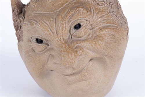 Lot 202 - A Martin Brothers double-sided stoneware face...
