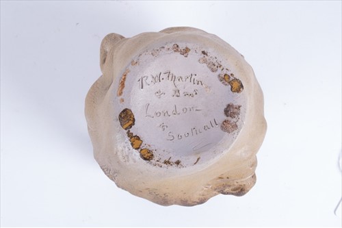 Lot 202 - A Martin Brothers double-sided stoneware face...