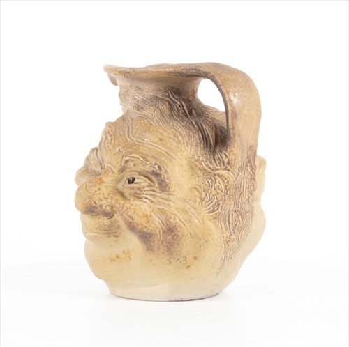 Lot 202 - A Martin Brothers double-sided stoneware face...