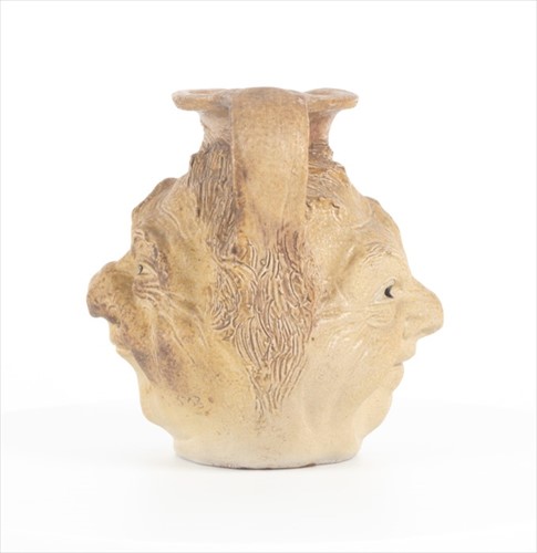 Lot 202 - A Martin Brothers double-sided stoneware face...