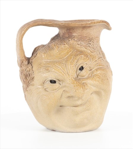 Lot 202 - A Martin Brothers double-sided stoneware face...