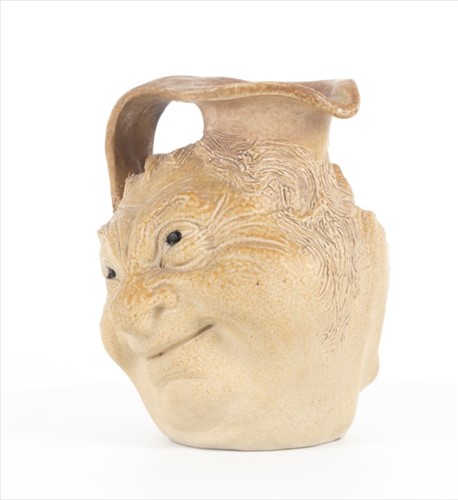 Lot 202 - A Martin Brothers double-sided stoneware face...