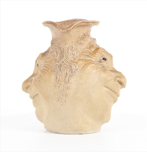Lot 202 - A Martin Brothers double-sided stoneware face...