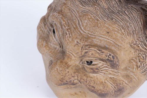 Lot 202 - A Martin Brothers double-sided stoneware face...