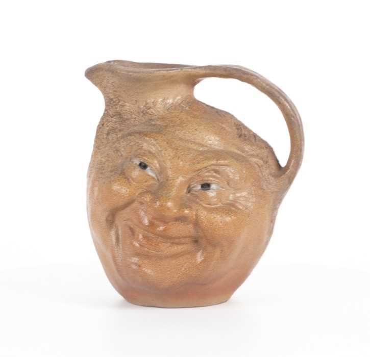 Lot 203 - A Martin Brothers double-sided stoneware face...