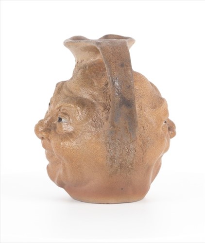 Lot 203 - A Martin Brothers double-sided stoneware face...