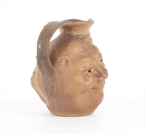 Lot 203 - A Martin Brothers double-sided stoneware face...
