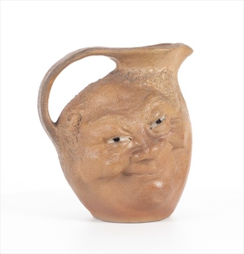 Lot 203 - A Martin Brothers double-sided stoneware face...