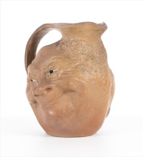 Lot 203 - A Martin Brothers double-sided stoneware face...