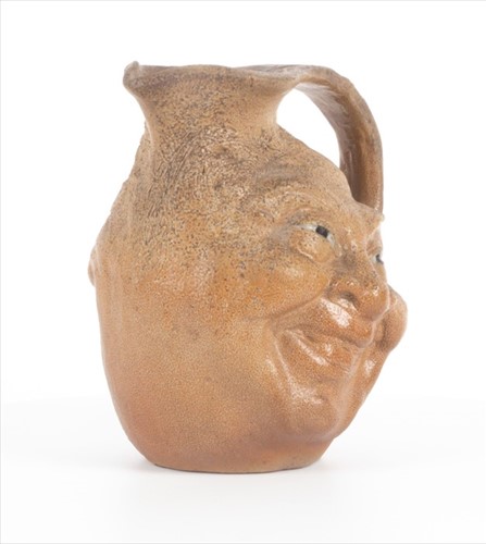 Lot 203 - A Martin Brothers double-sided stoneware face...
