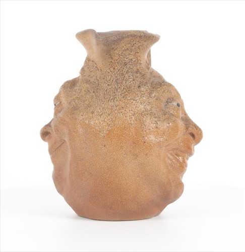 Lot 203 - A Martin Brothers double-sided stoneware face...