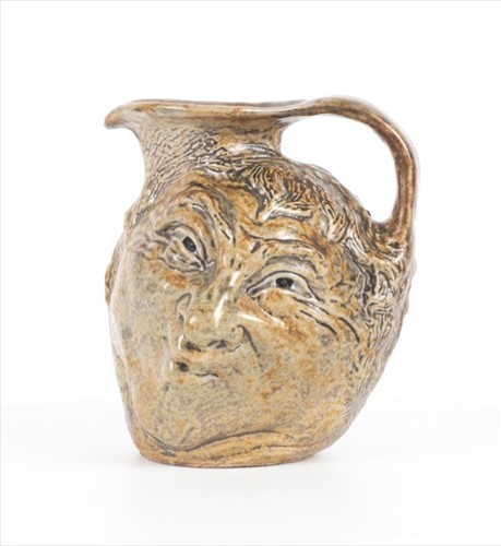 Lot 248 - A Martin Brothers double-sided stoneware face...