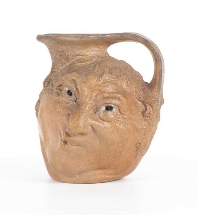 Lot 223 - A Martin Brothers double-sided stoneware face...