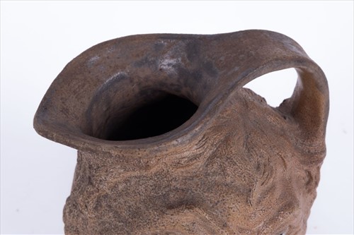 Lot 223 - A Martin Brothers double-sided stoneware face...