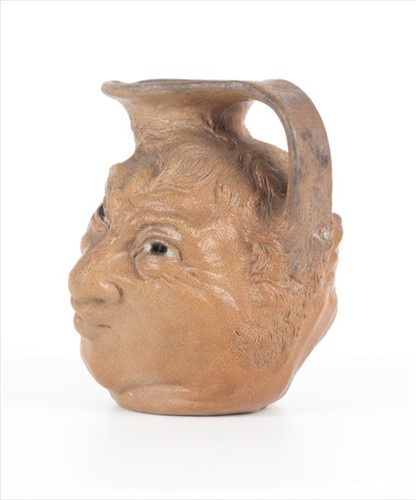 Lot 223 - A Martin Brothers double-sided stoneware face...