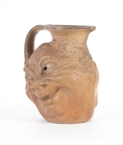 Lot 223 - A Martin Brothers double-sided stoneware face...