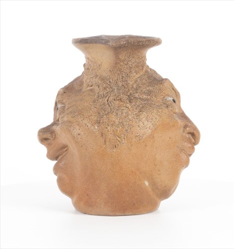 Lot 223 - A Martin Brothers double-sided stoneware face...
