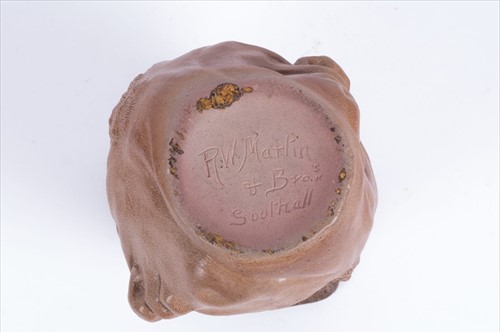 Lot 223 - A Martin Brothers double-sided stoneware face...