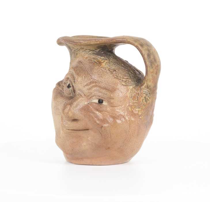 Lot 205 - A Martin Brothers double-sided stoneware face...