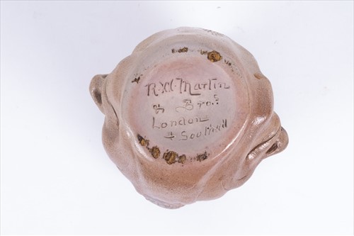 Lot 205 - A Martin Brothers double-sided stoneware face...