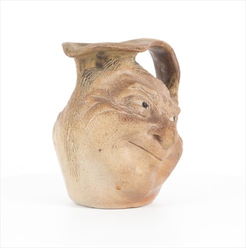 Lot 205 - A Martin Brothers double-sided stoneware face...