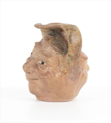 Lot 205 - A Martin Brothers double-sided stoneware face...