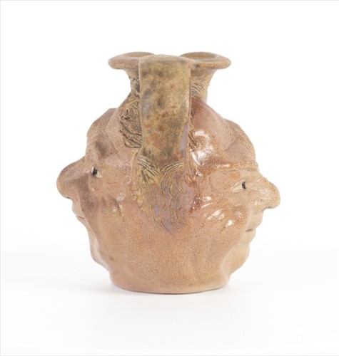 Lot 205 - A Martin Brothers double-sided stoneware face...