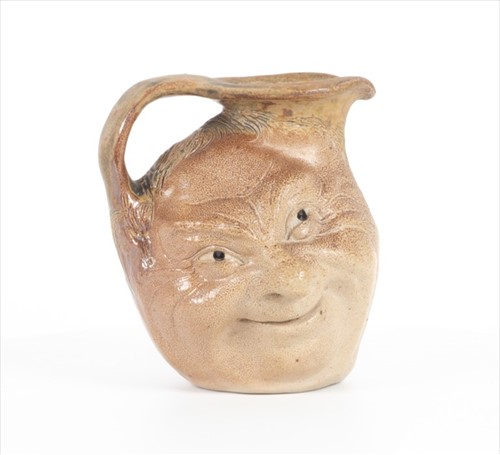 Lot 205 - A Martin Brothers double-sided stoneware face...
