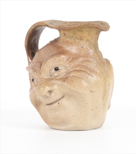 Lot 205 - A Martin Brothers double-sided stoneware face...