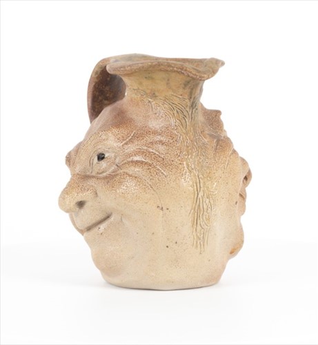 Lot 205 - A Martin Brothers double-sided stoneware face...